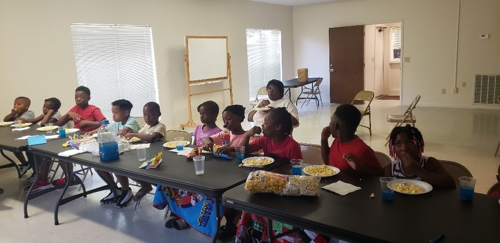 Lafayette youth watching movie and eating popcorn during summer camp