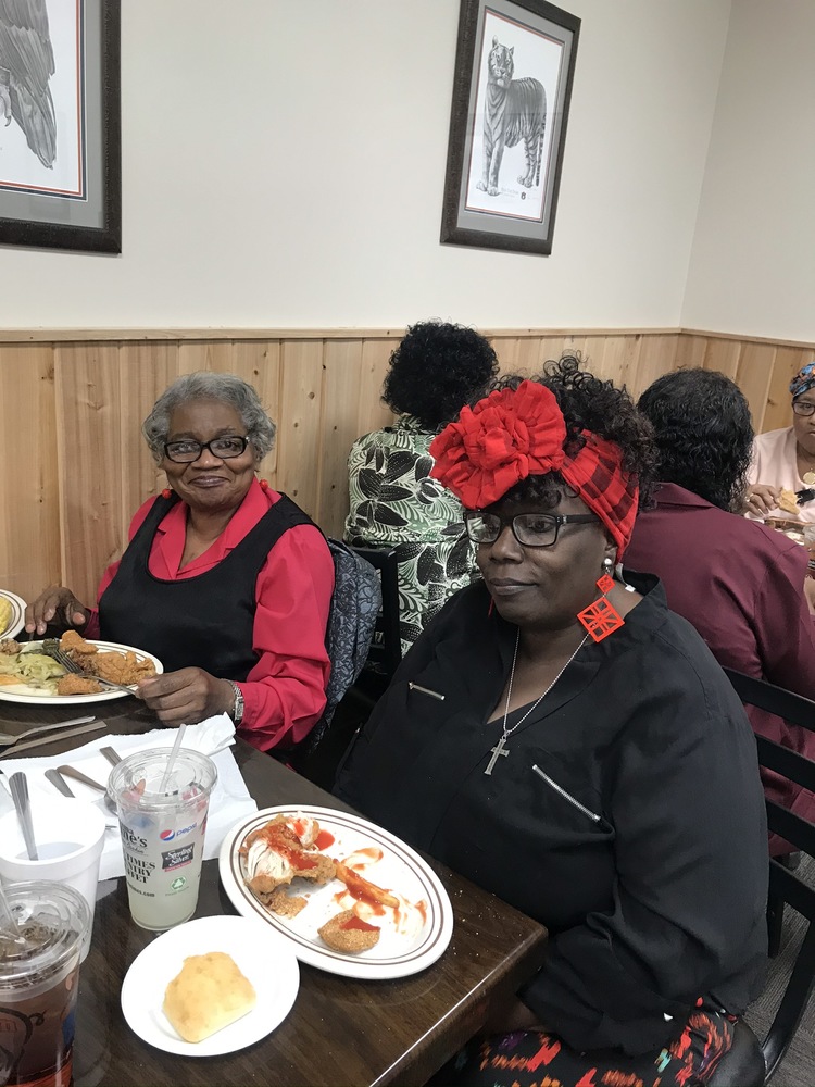 Two senior residents eating at our holiday luncheon 