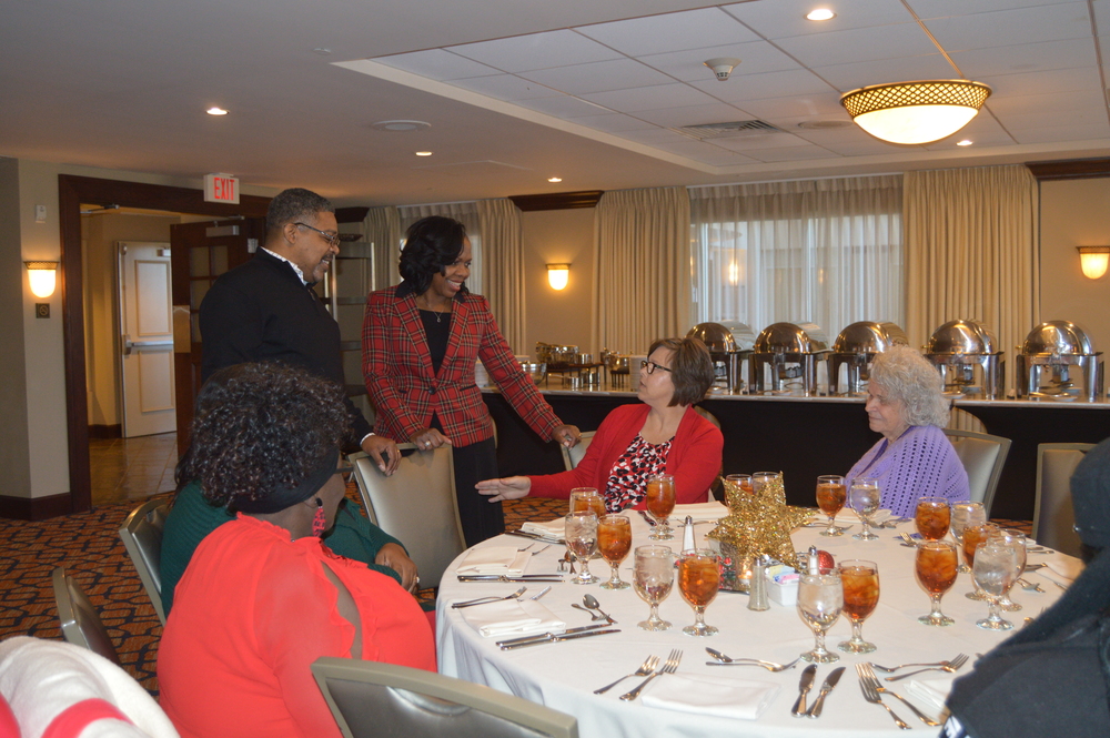 CEO Sharon Tolbert, husband, and employees at Christmas Luncheon in LHA newsletter