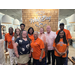 Auburn Housing Authority Staff and Commissioners are posed in front of a brick wall with text 'Wild Bay Seafood and Steak'