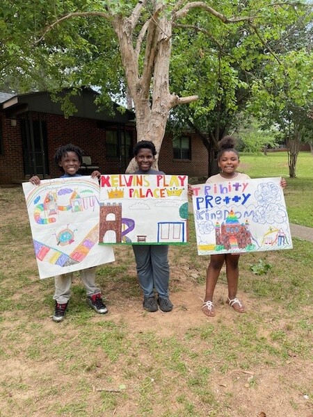 PosterCon5.jpg three young kids displaying their hai group poster contest submissions