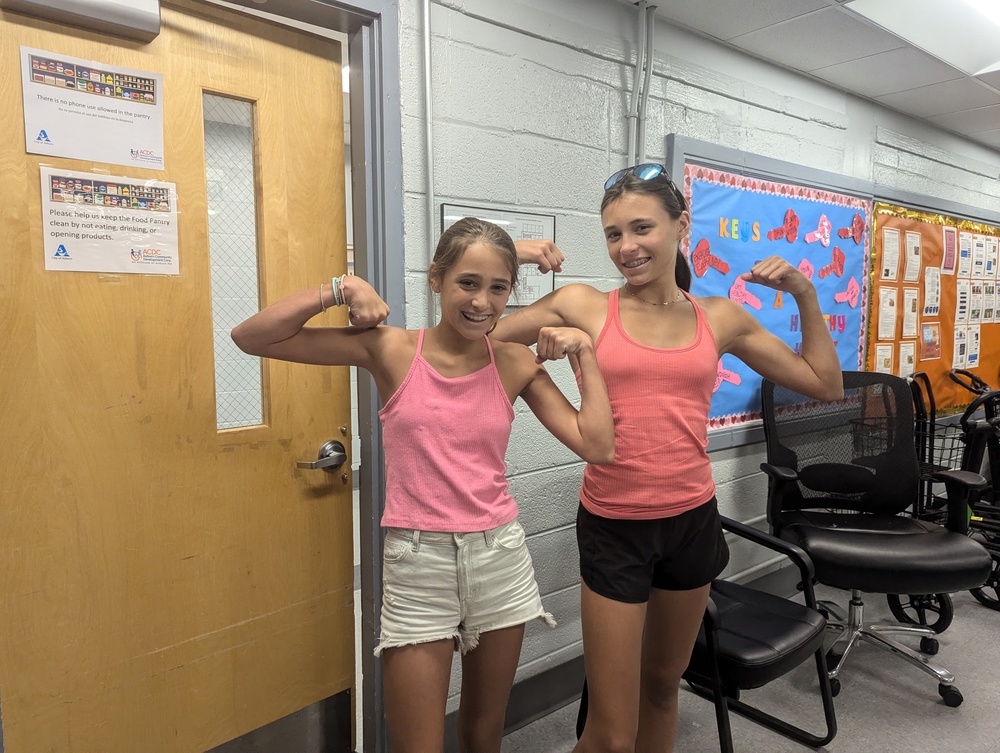 Food pantry volunteers showing off muscle