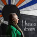 Commissioner, Marguerite White standing in front of a MLK &quot;I have a dream&quot; banner