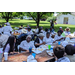 Large group of senior residents eating at picnic tables