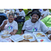 elderly women smiling for camera while eating 