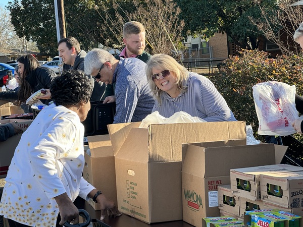 Volunteers interacting with Christmas market attendees.