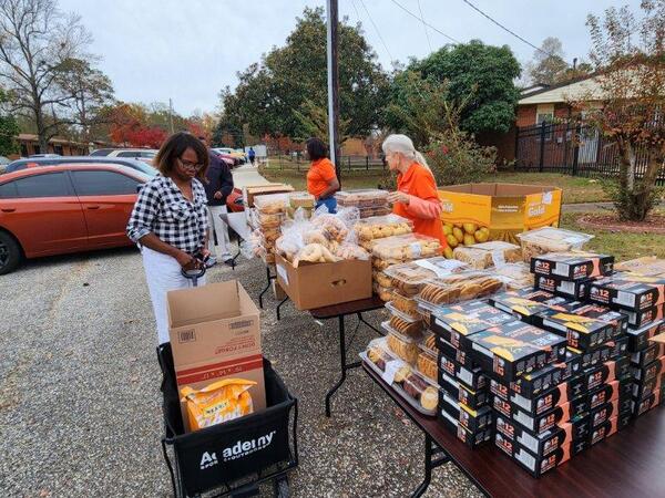 Thanksgiving Farmers Market setup outside with boxes of food.