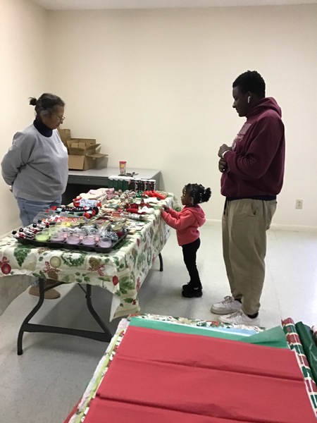 Residents choosing a gift from community table