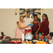 graduate with family members and staff holding blue envelope