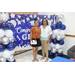 graduate and mother posed in front of backdrop