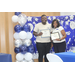 auburn high school male graduate with ceo tolbert in front of backdrop