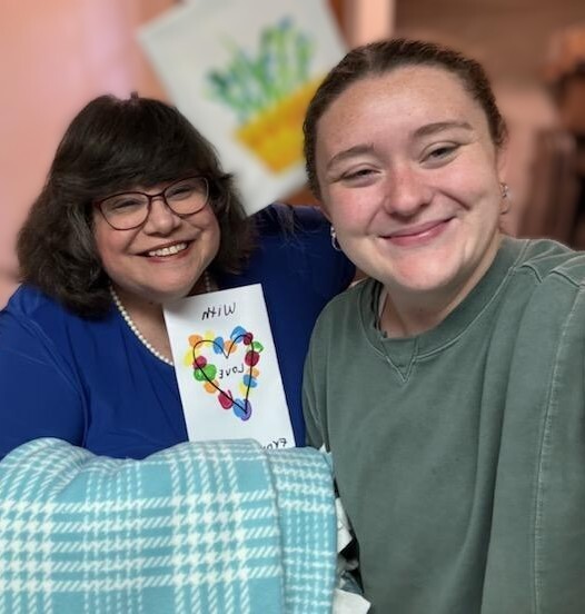 Charlotte Mattox and Bravehearts volunteer posed with blanket and card