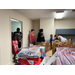 youth are lined up entering a room to receive school supplies 