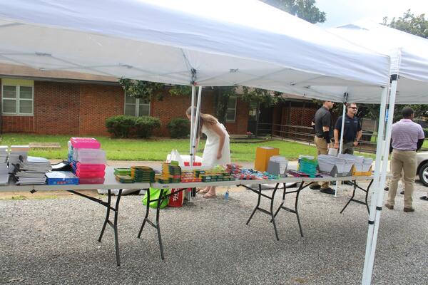 Tables with school supplies under tents