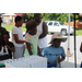 youth at school supply giveaway event behind a table of white binders