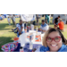 Tabitha Griffin in selfie position with Auburn Housing Authority staff sitting at vendor table behind her