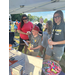 Attendees at Auburn Housing Authority vendor table receiving resources and candy