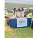 Auburn Housing Authority staff posed under tent behind their vendor table at National Night Out