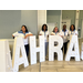 Staff and Commissioners behind tall AAHRA letters 