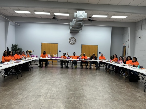 Auburn Housing Authority Employees sitting in a large room around a U-shaped desk